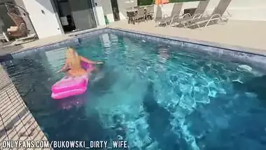 a beautiful blonde masturbates in the pool and lures a peeping guy into a blowjob