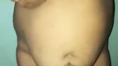 Desi woman with sexy fat tummy and big tits spreads pussy in XXX video